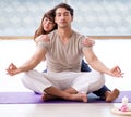 Personal coach helping during yoga session