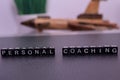 Personal Coaching on wooden blocks.