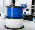 Personal 3d printer and abs or pla filament coils next to him..