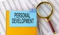 PERSONAL DEVELOPMENT text on sticker on notebook with magnifier and chart. Business concept Royalty Free Stock Photo