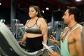 Personal fitness trainer helping a plus size woman