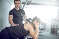 Personal fitness trainer with his client in gym. Royalty Free Stock Photo