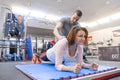 Personal fitness trainer working exercise with mature woman in the gym. Health fitness sport age concept Royalty Free Stock Photo