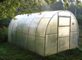 Personal greenhouse for cucumbers in the country. Royalty Free Stock Photo