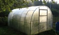 Personal greenhouse for cucumbers in the country. Royalty Free Stock Photo