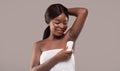 Personal Hygiene. Attractive Young Black Woman Applying Stick Deodorant To Armpit Zone Royalty Free Stock Photo