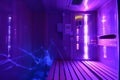 Personal infrared sauna illuminated by ultraviolet light Royalty Free Stock Photo