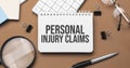 Personal injury claims on notepad with pen, glasses and calculator Royalty Free Stock Photo