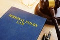 Personal injury law on a desk and gavel. Royalty Free Stock Photo