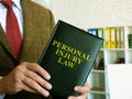 Personal injury law. A lawyer in a suit holds book. Royalty Free Stock Photo