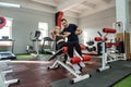 personal male trainer working with young slim woman client in gym Royalty Free Stock Photo