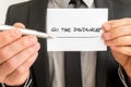 Personal motivator holding up a white card with a Go the distance sign Royalty Free Stock Photo