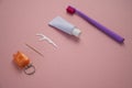 Personal oral hygiene product on a pink background. Toothbrush tube toothpaste toothpick and floss. Flat lay Royalty Free Stock Photo