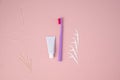 Personal oral hygiene product on a pink background. Toothbrush tube toothpaste toothpick and floss. Flat lay. Copy space Royalty Free Stock Photo