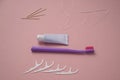 Personal oral hygiene product on a pink background. Toothbrush tube toothpaste toothpick and floss. Flat lay. Copy space Royalty Free Stock Photo