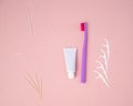 Personal oral hygiene product on a pink background. Toothbrush tube toothpaste toothpick and floss. Flat lay. Copy space Royalty Free Stock Photo