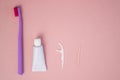 Personal oral hygiene product on a pink background. Toothbrush tube toothpaste toothpick and floss. Flat lay. Copy space Royalty Free Stock Photo