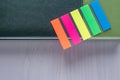 Personal organizer with multicolored bookmarks on wooden table