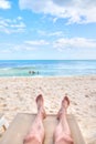 Personal perspective of man relaxing at beach with feet view Royalty Free Stock Photo