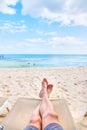 Personal perspective of man relaxing at beach with feet view Royalty Free Stock Photo