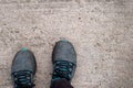 Personal perspective from top view of man standing on concrete Footpath or cement floor