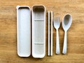 Personal plastic utensils set on wooden table