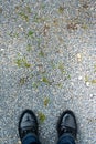 Personal point of view of person standing on pebbles ground