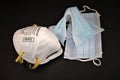 N95 Respirator and surgical masks on black background Royalty Free Stock Photo