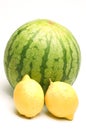 Personal size watermelon and two lemons Royalty Free Stock Photo