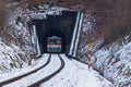 A personal train enters the tunnel and snow Royalty Free Stock Photo