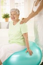 Personal trainer assisting senior woman Royalty Free Stock Photo