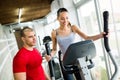 Personal trainer assisting woman lose weight Royalty Free Stock Photo