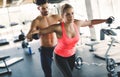 Personal trainer assisting woman lose weight Royalty Free Stock Photo