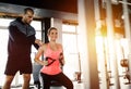 Personal trainer assisting woman lose weight Royalty Free Stock Photo