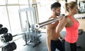 Personal trainer assisting woman lose weight Royalty Free Stock Photo