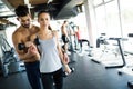 Personal trainer assisting woman lose weight Royalty Free Stock Photo