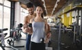 Personal trainer assisting woman lose weight Royalty Free Stock Photo