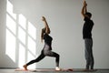 Trainer correct his client while doing yoga exercise. Royalty Free Stock Photo