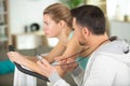 personal trainer encouraging tired woman to continue exercising Royalty Free Stock Photo