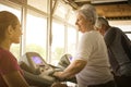 Personal trainer exercise helps elderly couple. Royalty Free Stock Photo