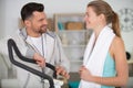 personal trainer explaining settings on exercise machine Royalty Free Stock Photo
