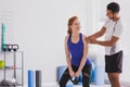 Personal trainer giving instructions to his client who it with is working out with a kettle bell Royalty Free Stock Photo