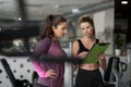 Personal trainer guiding young woman