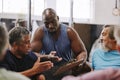 Personal trainer, gym checklist and black man talking to senior clients for training progress, coaching advice or Royalty Free Stock Photo