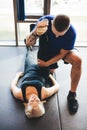 Personal trainer helping woman in stretching Royalty Free Stock Photo