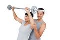 Personal trainer helping woman with weight lifting bar Royalty Free Stock Photo