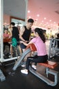 Asian chinese woman in gym lifting weights Royalty Free Stock Photo