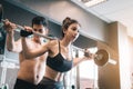 Personal trainer helping women and handle heavy barbells two han Royalty Free Stock Photo