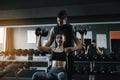 Personal trainer helping woman working lift heavy dumbbells two Royalty Free Stock Photo