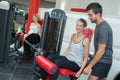 Personal trainer helping women working out in gym Royalty Free Stock Photo